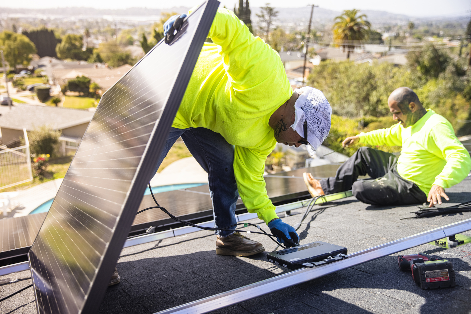Hispanic Man Connecting Solar Panels to Micro Inverters
