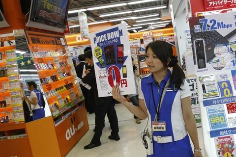 An employee promotes mobile phones at an electronics shop in Tokyo June 17, 2009. Japan