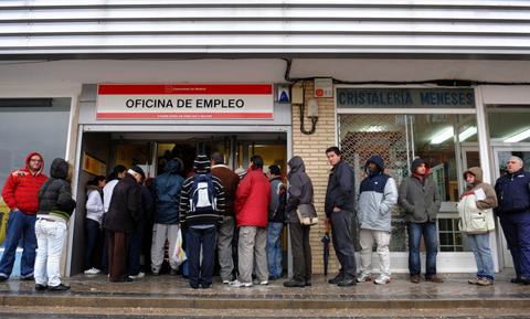 Unemployed wait in line at a government employment office on February 5, 2009 in Madrid, Spain. With compagnies shedding tens of thousand of jobs due to the fall in of the Spanish property boom, the number of people out of work in Spain has risen to a 12 year high in January with more than 3.3 million out of work, 13% of the Spanish population.