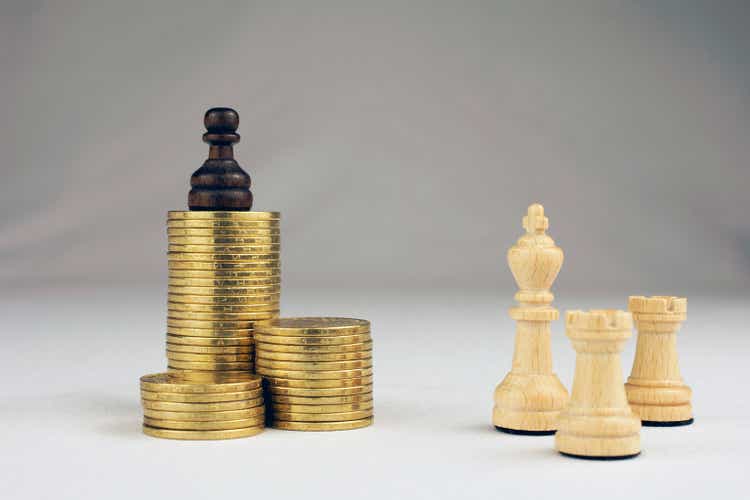 chess pieces piles of gold coins crisis intervention concept