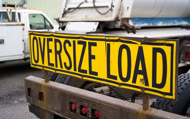 Oversize load sign on the back of big rig semi truck tractor on the parking lot