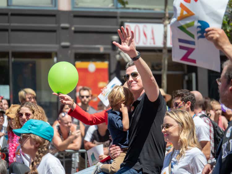 Former San Francisco Mayor Gavin Newsom waves at the crowd at the 2018 San Francisco Pride Parade