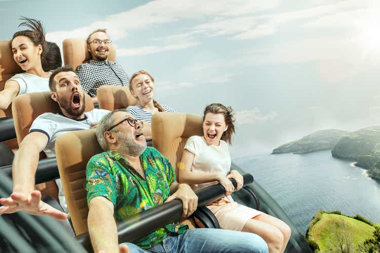 The happy emotions of men and women having good time on a roller coaster in the park