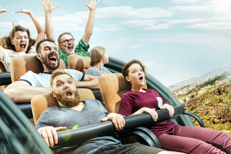 The happy emotions of men and women having good time on a roller coaster in the park