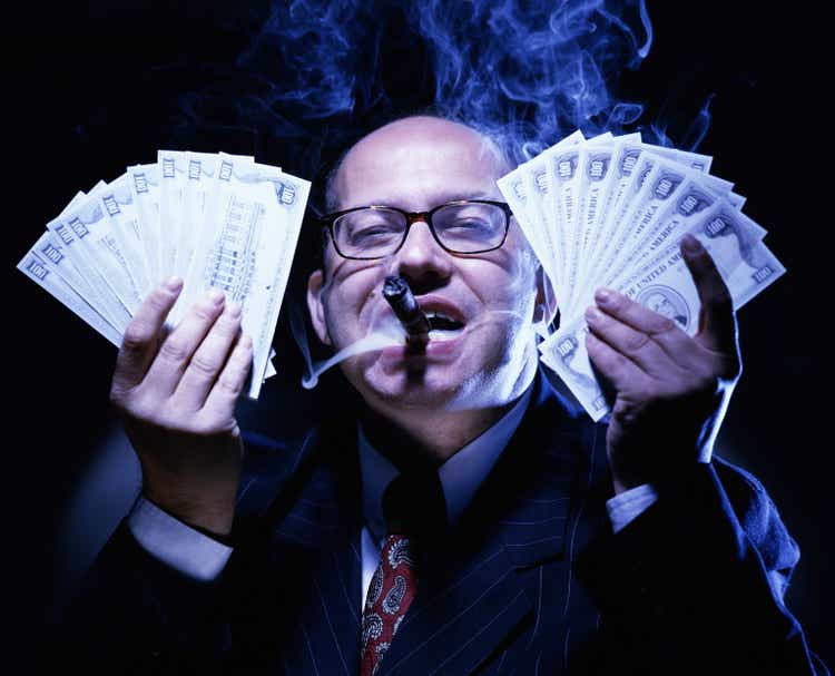 BUSINESSMAN WITH MONEY, SMOKING CIGAR