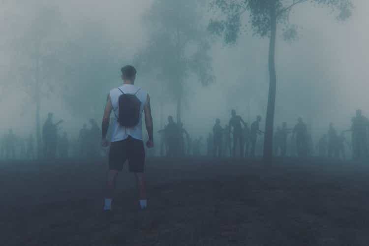 Young adult against zombie hordes