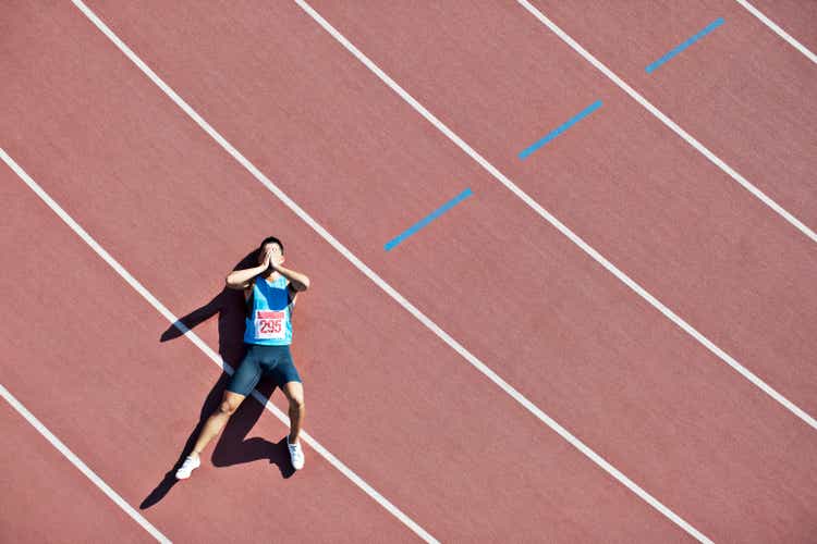 Tired runner laying on track