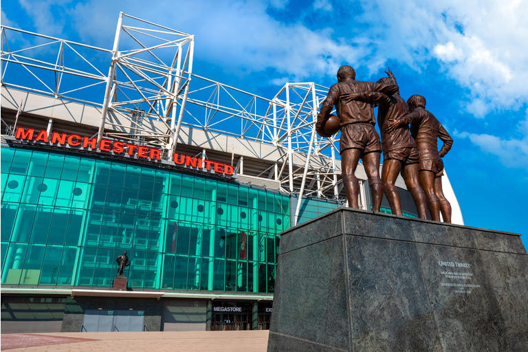 The United Trinity bronze sculpture at Old Trafford stadium in Manchester, UK