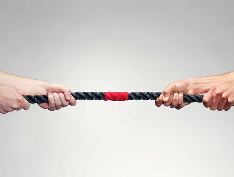 Hands pulling on rope during game of tug-of-war