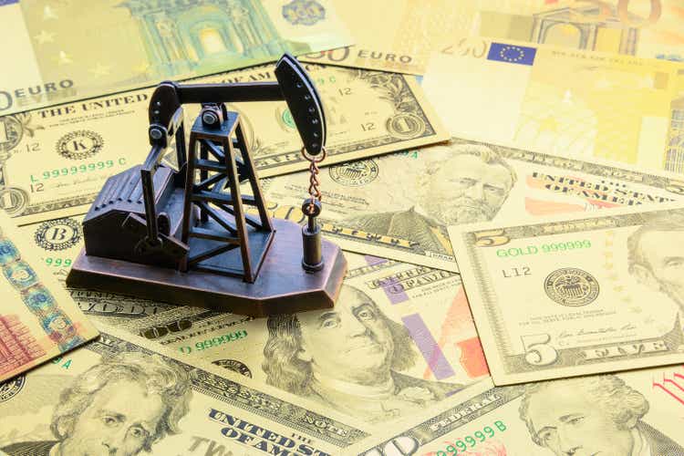 Petroleum, petrodollar and crude oil concept : Pump jack or drilling rig on US USD dollar bank notes, depict the money received or earned from sales after investment in the development of oil industry