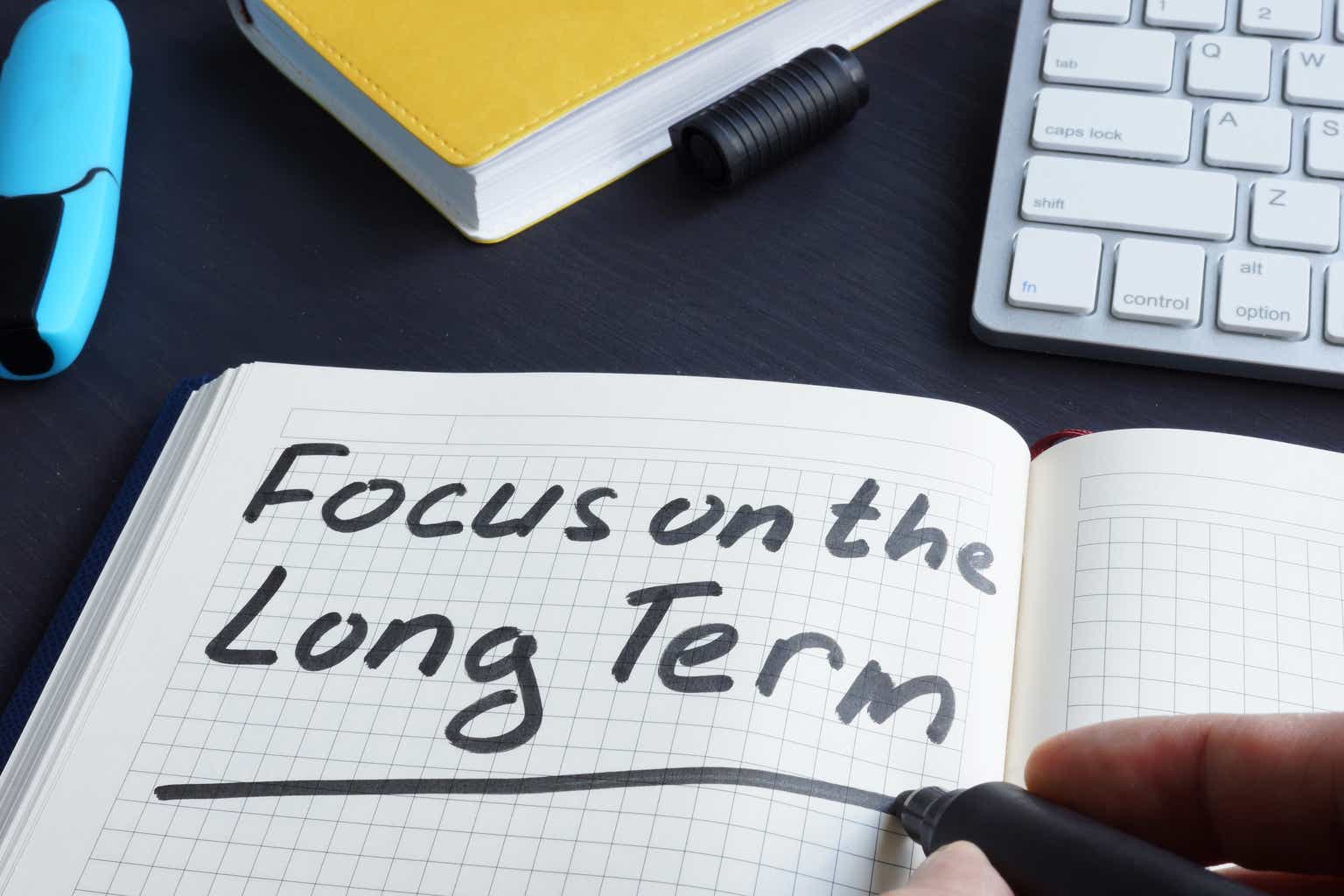 Man is writing focus on the long term.