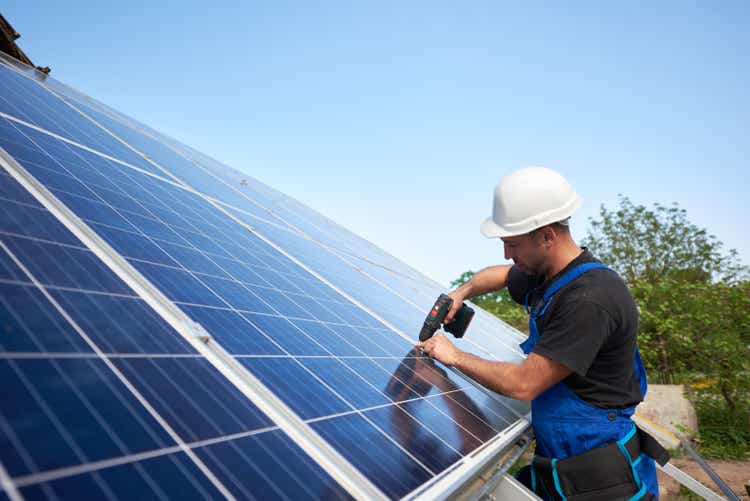 Installing an outdoor standalone solar panel system, renewable green energy generation concept.