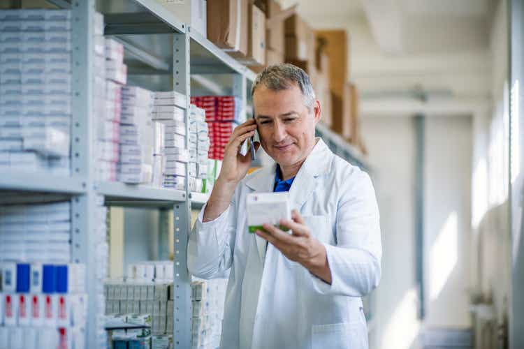 Medical factory supplies storage indoor with chemist man
