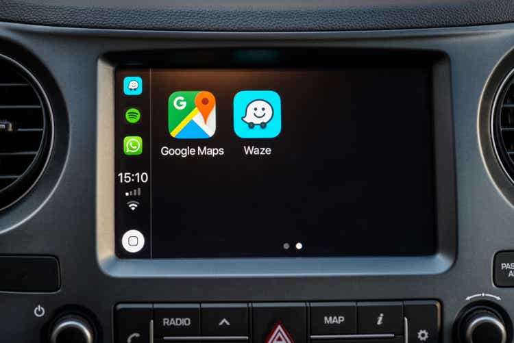 Apple Carplay screen in car dashboard displaying Google Maps and Waze apps