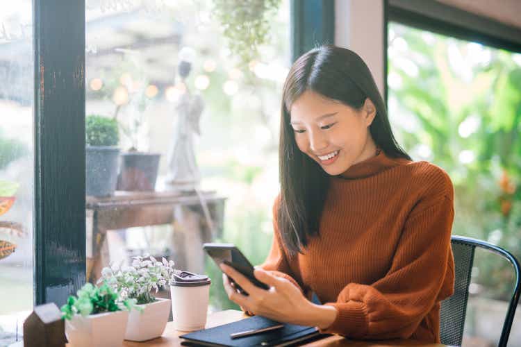 Young Asian woman using phone