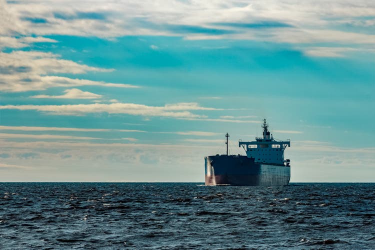 Blue cargo ship underway