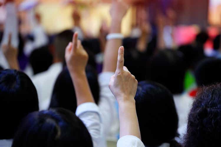 POINT Biopharma Global: Why The Market Believes That A Second Bidder May Emerge 1 people reacting to the question by raising their index finger together as teamwork for unity and unanimous agreement and collabora