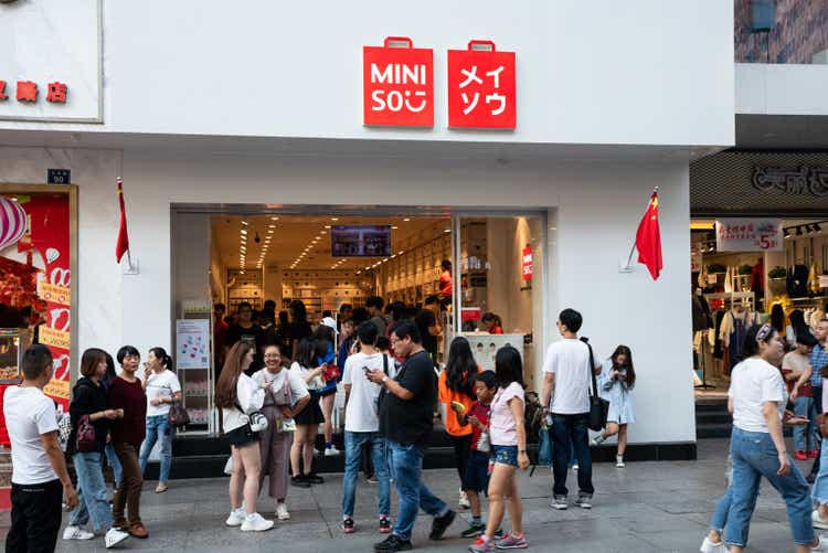 Exterior of Miniso flagship store with people in Wuhan China