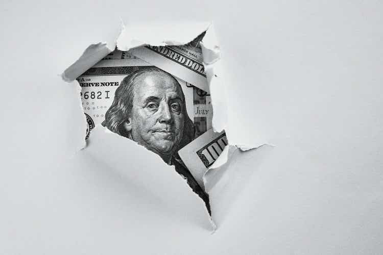 Money under holed paper