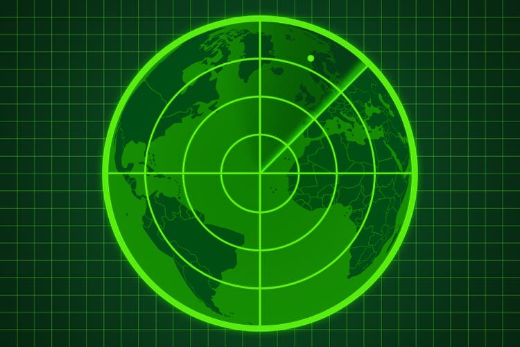 Green radar screen with a dot on the world map