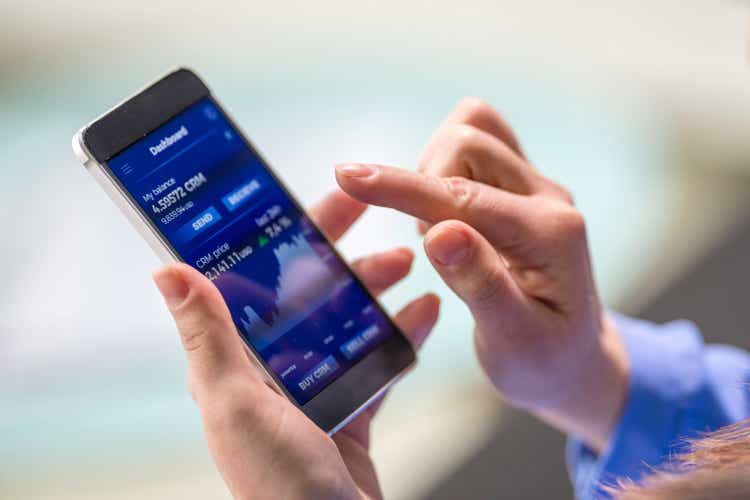 Woman buying cryptocurrency through mobile phone app