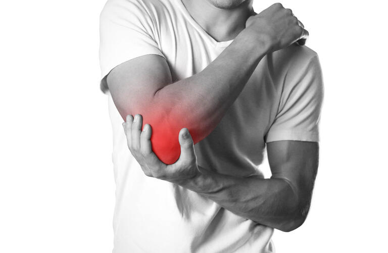 A man holding hands. Pain in the elbow. The hearth is highlighted in red. Close up. Isolated on white background
