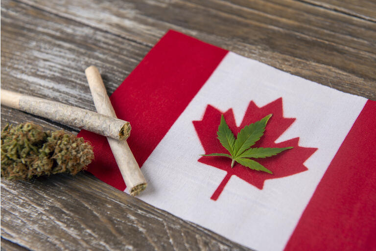 Canadian flag with assorted marijuana products