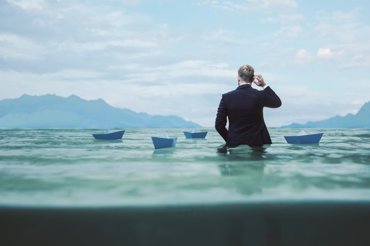 Lost and confused businessman in water