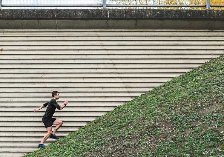 man running up a steep hill