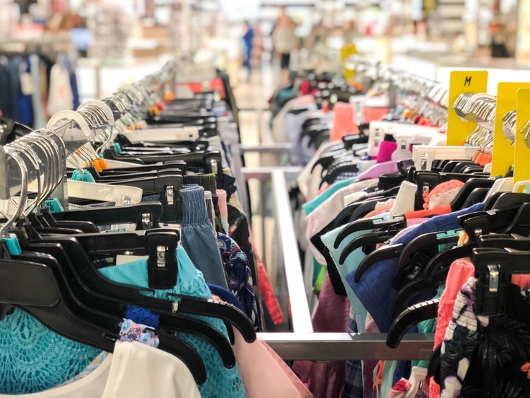 Women"s Clothing of Different Colors on Hangers in Department Store Black Friday