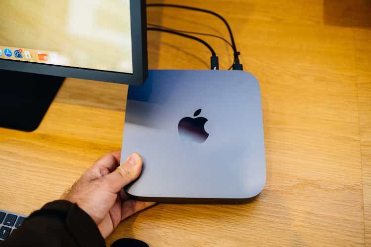 Hand holding New Apple Mac Mini 2018 computer