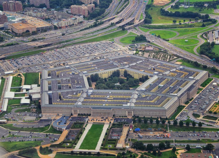 Aerial view of the United States Pentagon, the Department of Defense headquarters in Arlington, Virginia, near Washington DC, with I-395 freeway and the Air Force Memorial and Arlington Cemetery nearby.