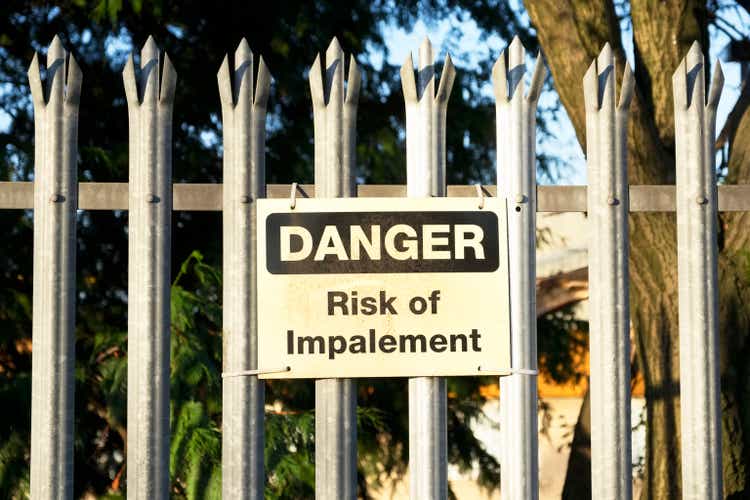 Impalement danger and risk sign on fence for security and protection