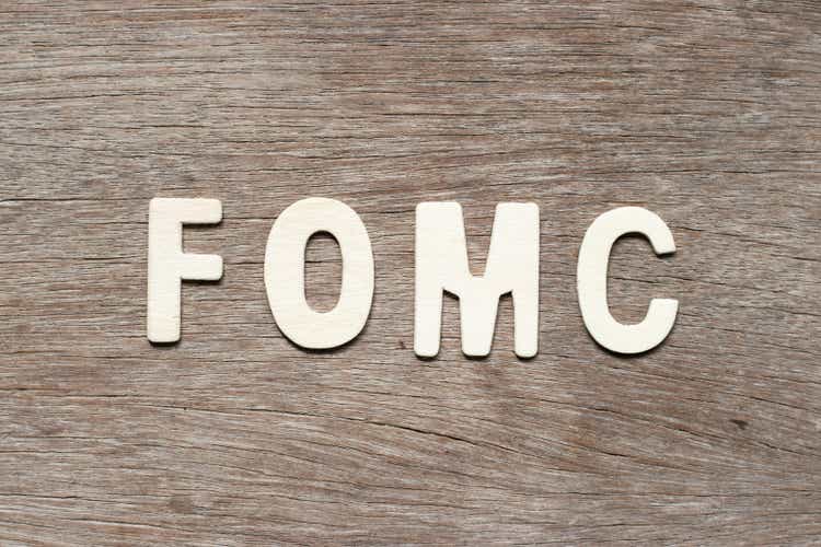 Alphabet letter in word fomc (abbreviation of federal open market committee) on wood background