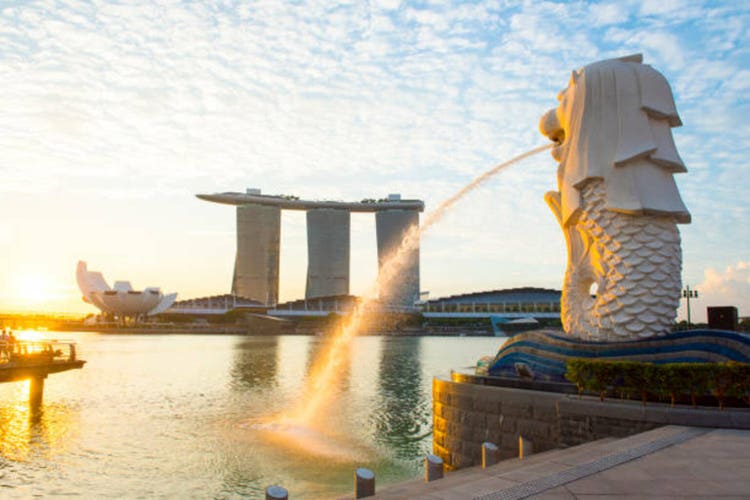 Singapore skyline of financial district with modern office buildings and Merlion Park as seen from Esplanade.