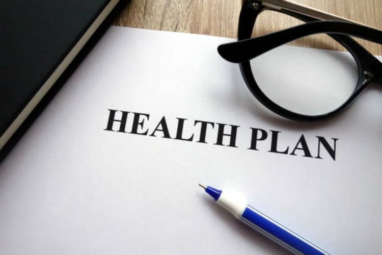 Health plan form, pen and glasses