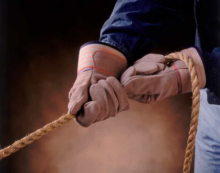 Pair of Gloved Hands Pulling on Rope