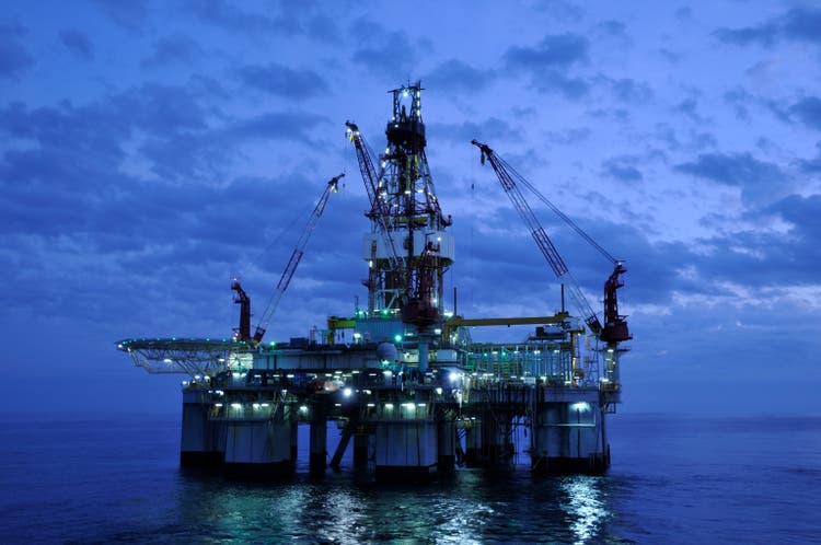 Off Shore Drilling Platform at Twilight. Oil rig and reflection