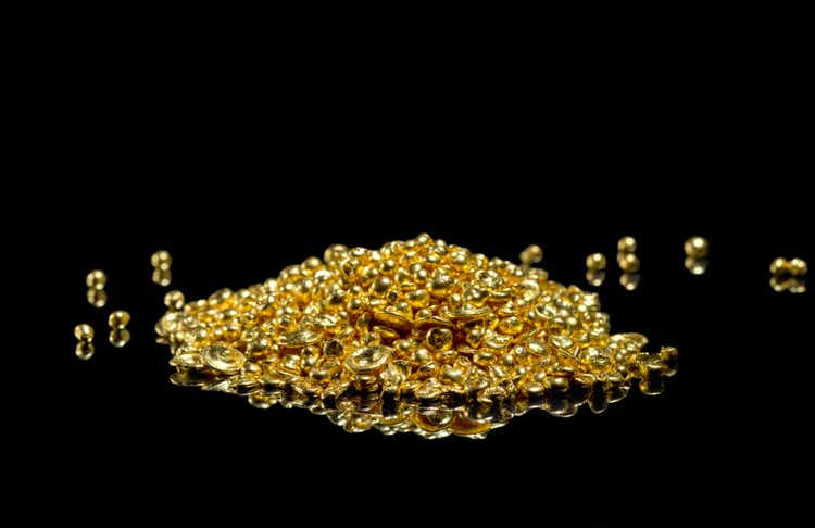 A bunch of gold grains. Isolated on a black