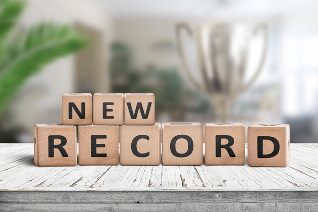 New record sign on a wooden table in a bright room