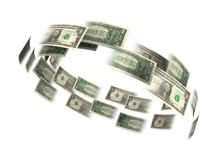 Dollar bills flying in a circle
