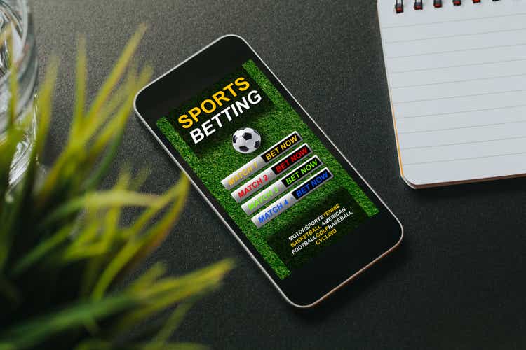 Mobile phone with sports betting website app in the screen.