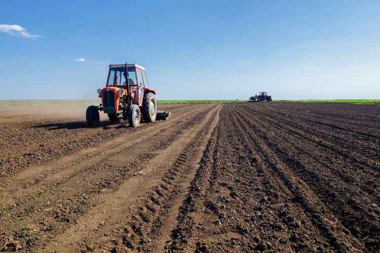 Tractors sowing on agricultural field in spring
