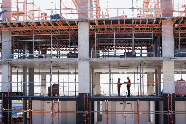 Construction workers shaking hands on construction site