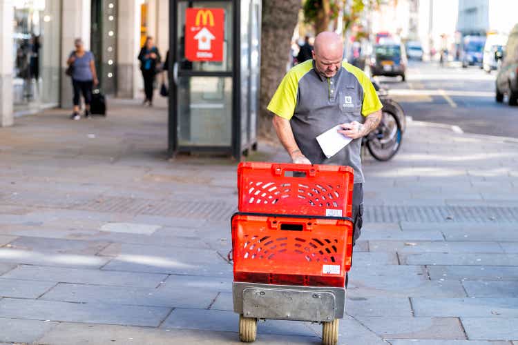 Ocado online store grocery shopping delivery supermarket with man and baskets in Chelsea