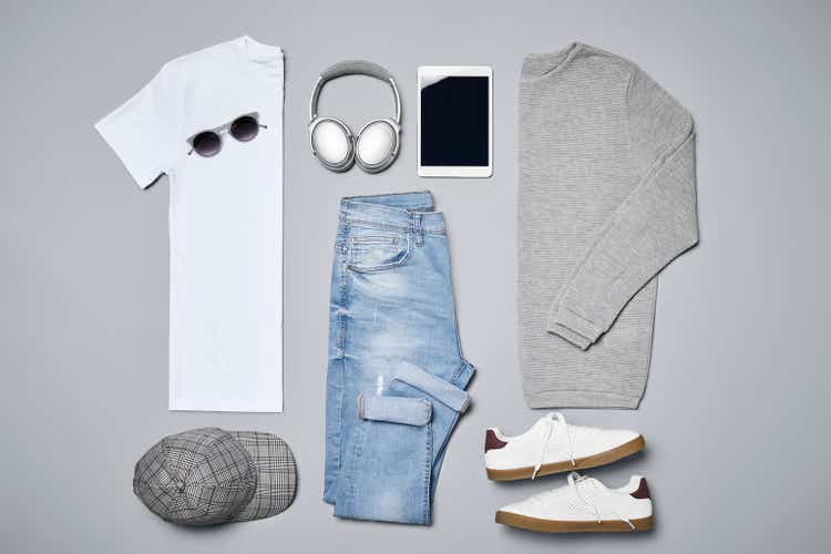 Flat lay of menswear with personal accessories