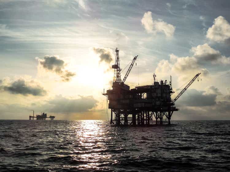 Offshore oil platform at sunset.