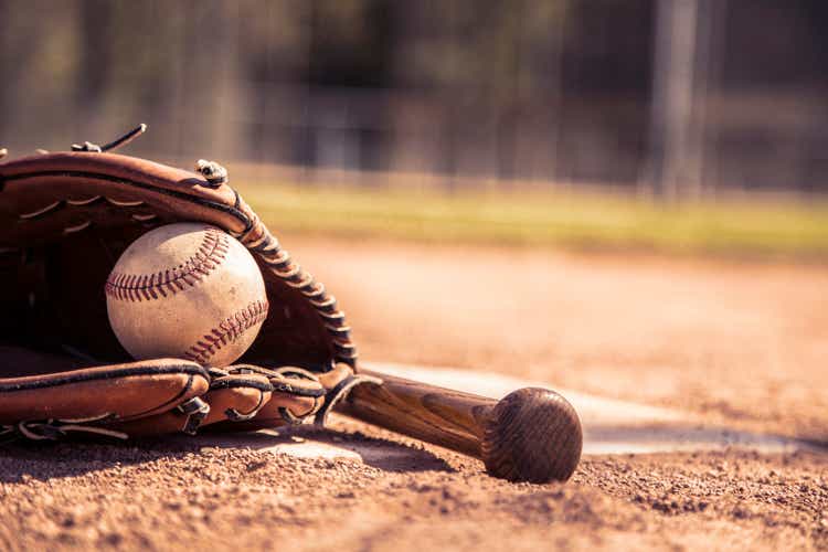 Baseball season is here. Bat, glove and ball on home plate.
