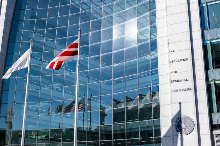 United States Securities and Exchange Commission SEC architecture closeup with modern building sign and logo with red flags by glass windows
