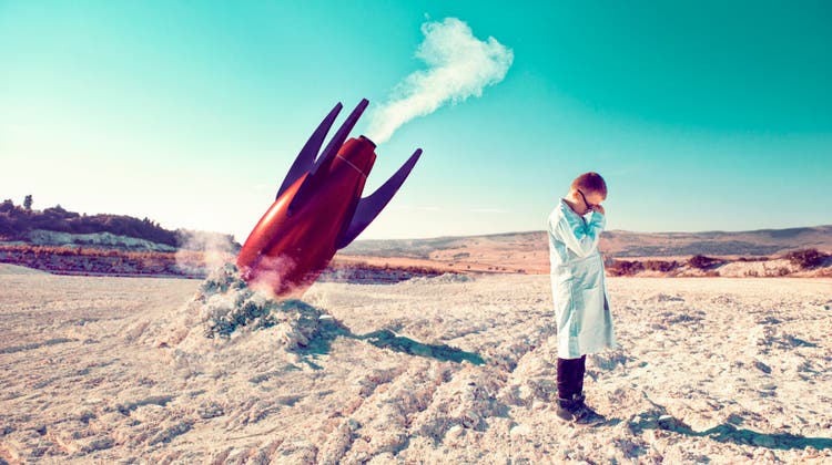 Rocket fails and falls to the ground while child in lab coat shows his disbelief